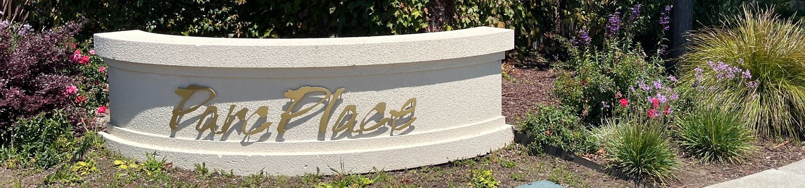 The ParcPlace of South San Francisco entrance monument, framed by landscaping and a flowering bed.
