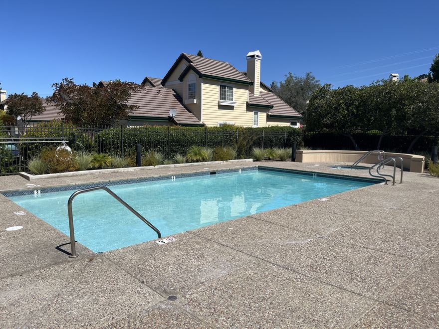 The Chaparral Springs community pool and spa with the hillside beyond.